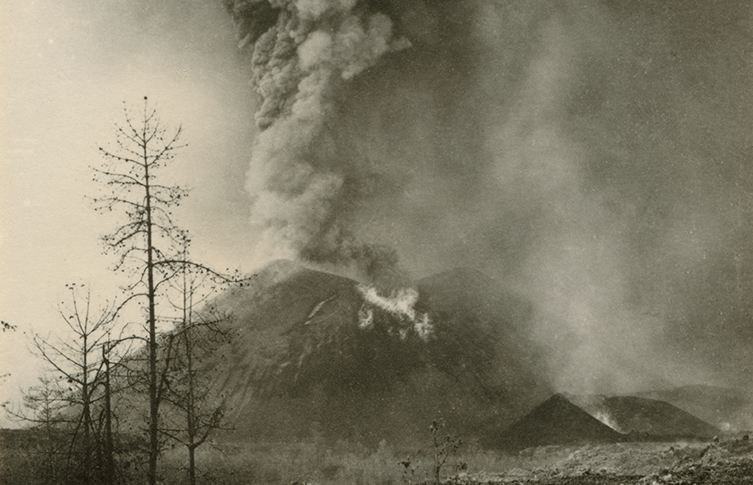 A sepia photograph of the cinder cone Parícutin erupting. 